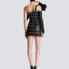 Asymmetrisches, figurbetontes Lederkleid mit Ketten Asymmetrisches, figurbetontes Lederkleid mit Ketten